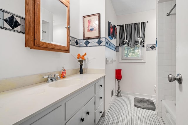 bathroom with tile patterned flooring, vanity, and shower / bath combination