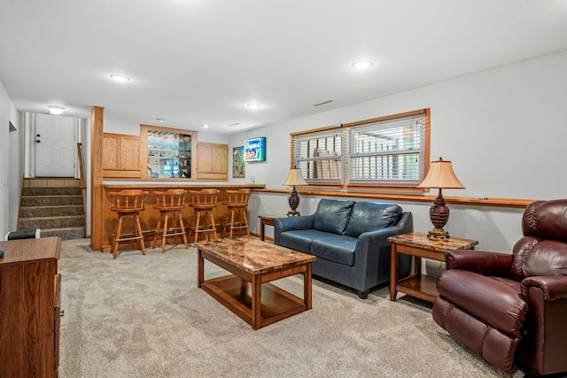 carpeted living room featuring indoor bar