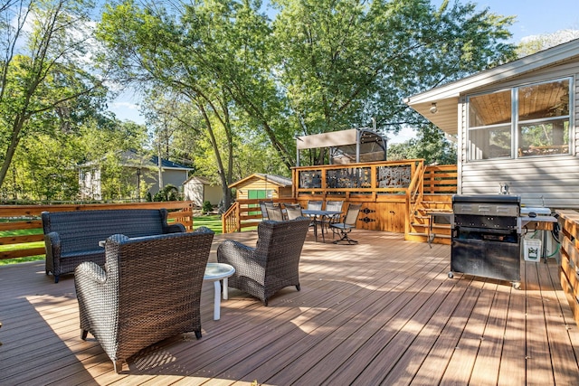 wooden deck with outdoor lounge area and grilling area