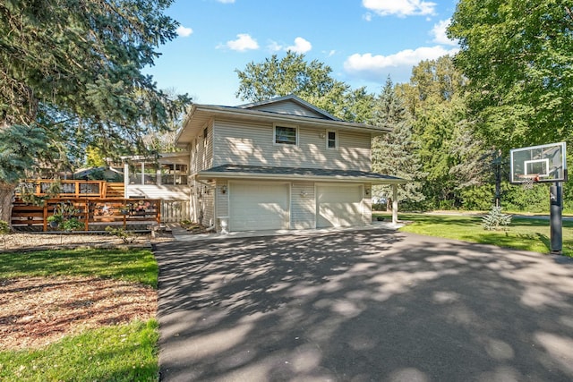 view of property exterior featuring a garage and a wooden deck