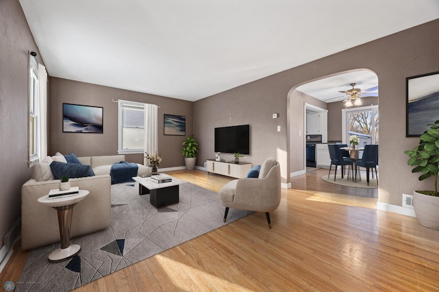 living room featuring wood-type flooring and ceiling fan