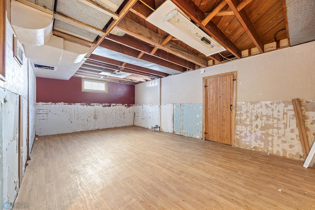 basement with hardwood / wood-style flooring