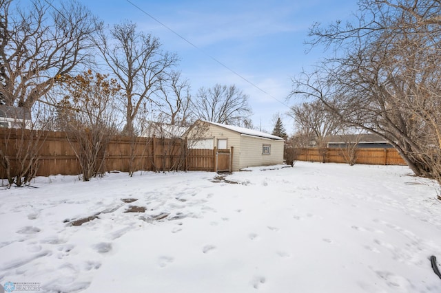 snow covered property featuring an outbuilding