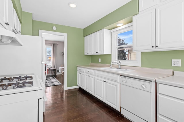 kitchen with white cabinets, white appliances, plenty of natural light, and sink