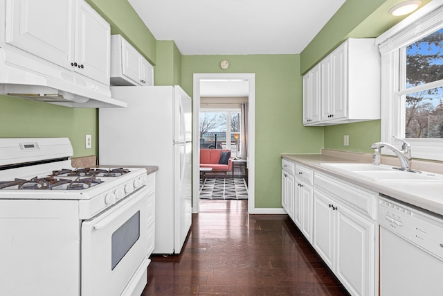 kitchen with sink, white appliances, dark hardwood / wood-style floors, and white cabinets