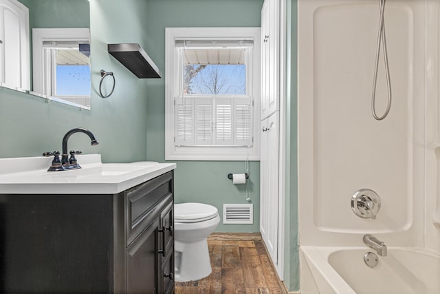 full bathroom with vanity, shower / tub combination, toilet, and wood-type flooring