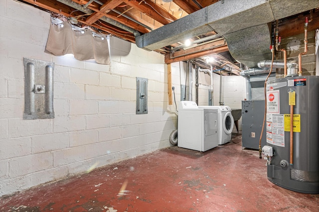 basement featuring washer and dryer, electric panel, and water heater