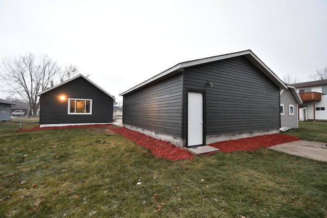 view of outdoor structure featuring a lawn