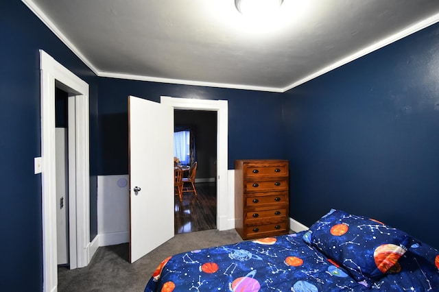 unfurnished bedroom with ornamental molding and carpet flooring