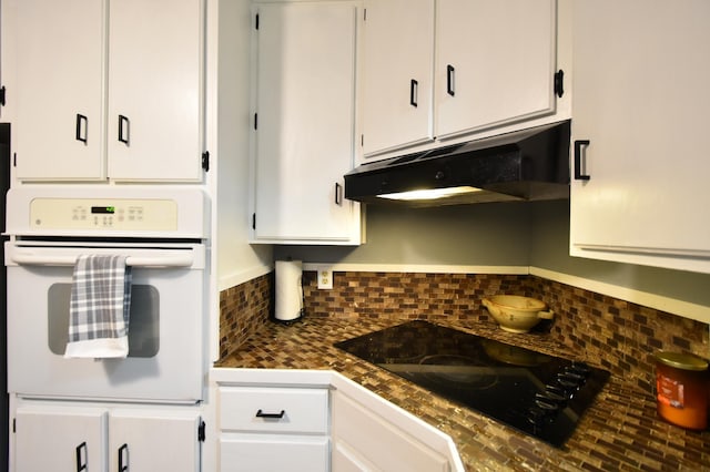 kitchen with tasteful backsplash, oven, white cabinets, and black electric cooktop