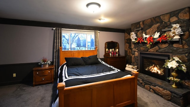 carpeted bedroom featuring a fireplace