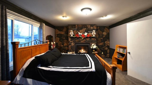 carpeted bedroom with a fireplace