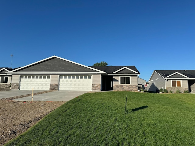 ranch-style house with a garage and a front lawn