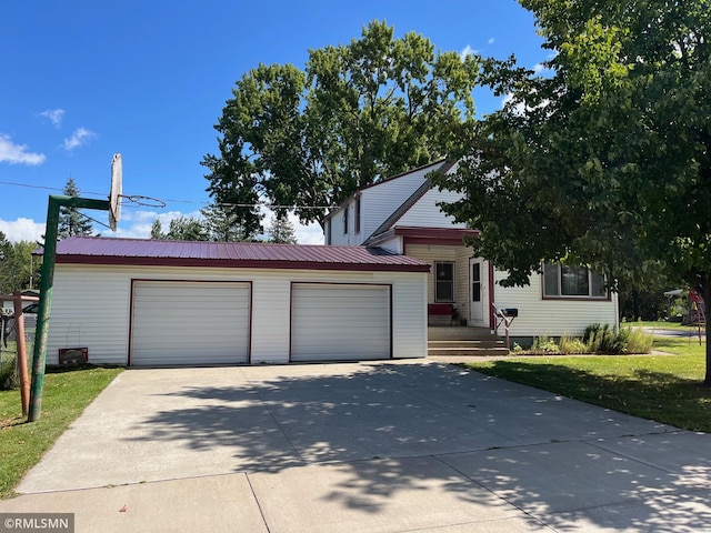 view of front of property with a garage and a front lawn