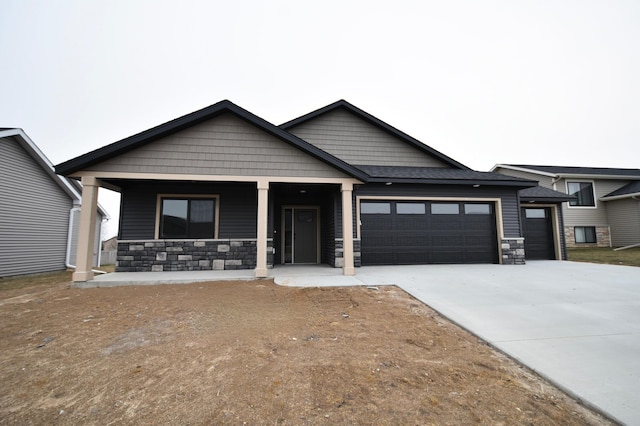 view of front of home featuring covered porch and a garage