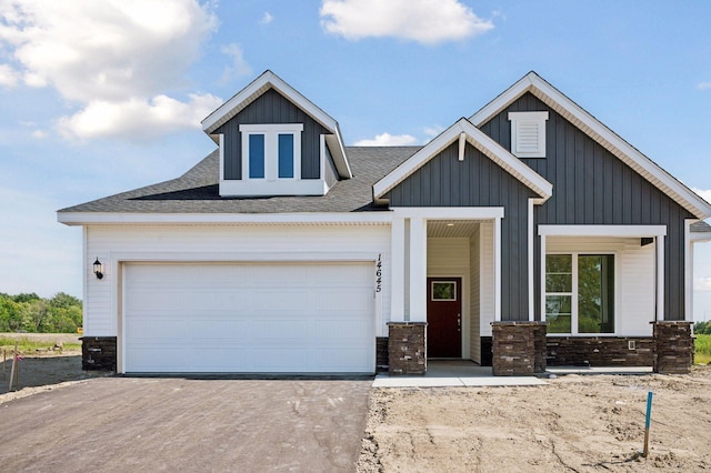 view of front of property with a porch and a garage