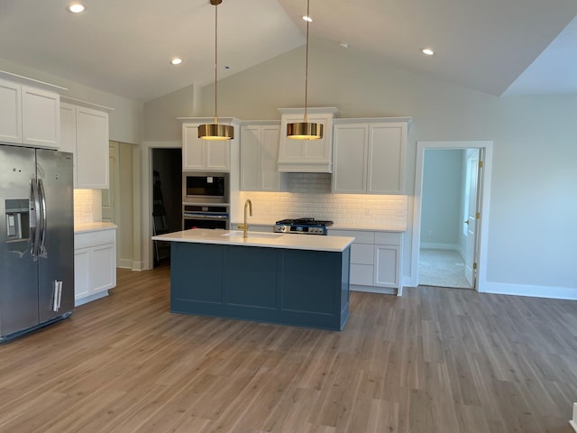 kitchen featuring a sink, light wood-style floors, appliances with stainless steel finishes, and light countertops