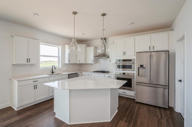 kitchen with white cabinetry, sink, pendant lighting, a kitchen island, and appliances with stainless steel finishes