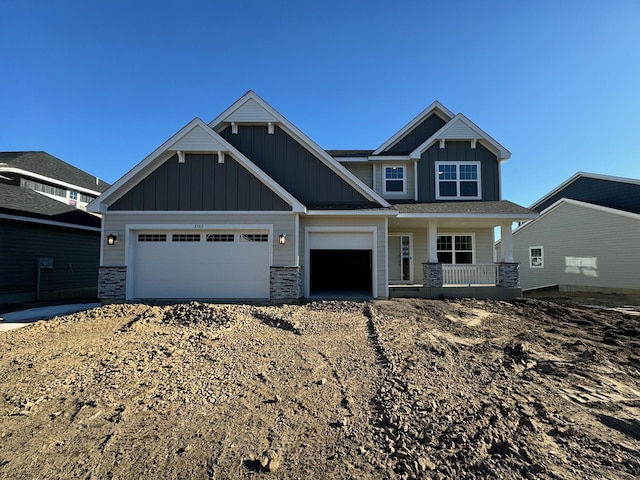 craftsman-style home featuring a porch and a garage