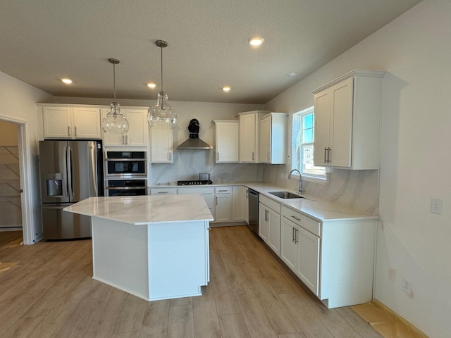 kitchen with white cabinetry, a center island, sink, stainless steel appliances, and decorative backsplash