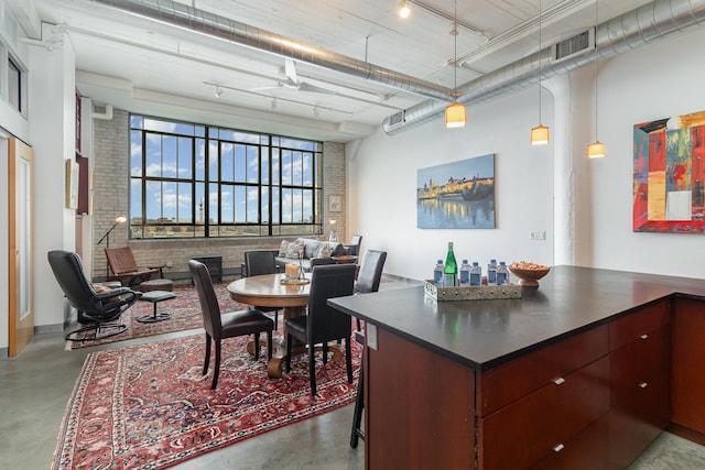 interior space featuring a high ceiling and brick wall