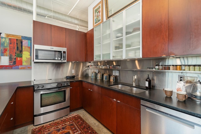 kitchen featuring sink, decorative backsplash, and appliances with stainless steel finishes