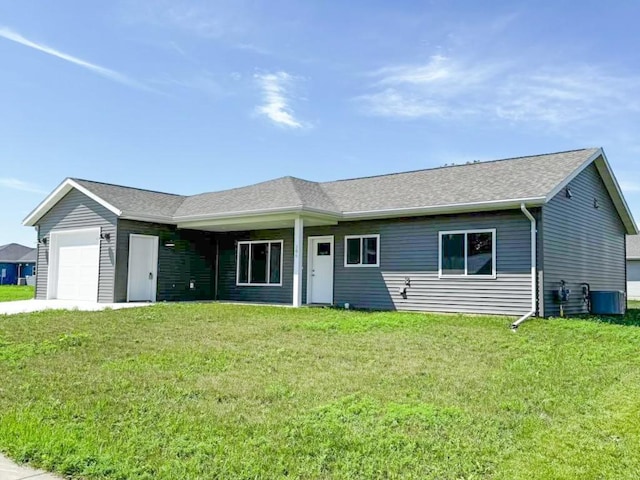 single story home with a garage and a front lawn