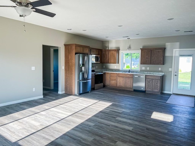 kitchen with a wealth of natural light, ceiling fan, stainless steel appliances, and hardwood / wood-style flooring