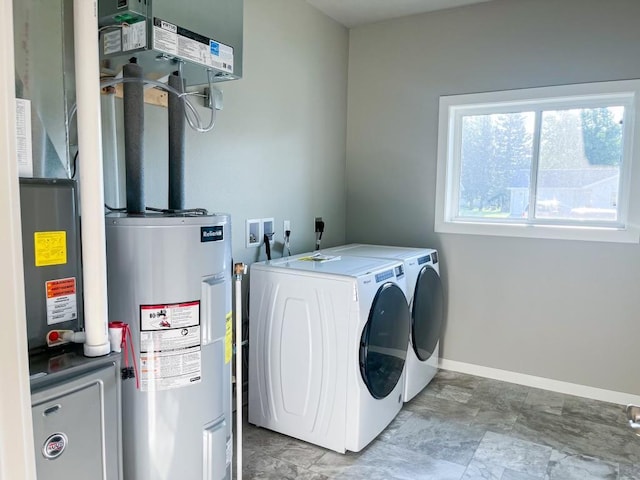 washroom featuring washing machine and dryer and electric water heater