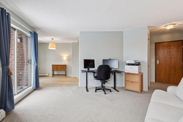 carpeted office with a textured ceiling, plenty of natural light, and a baseboard radiator