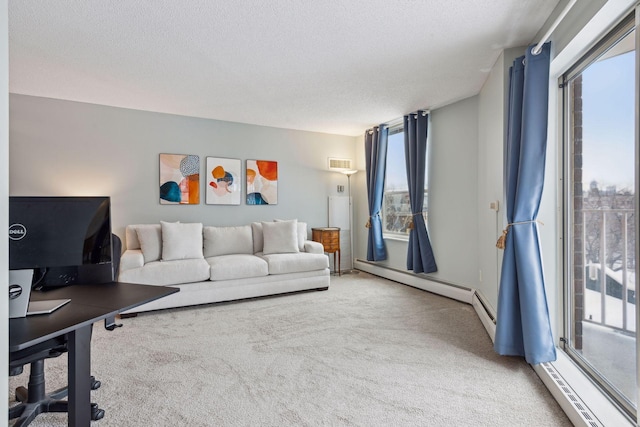 living room with plenty of natural light, a textured ceiling, and carpet