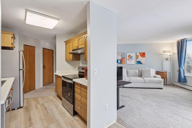 kitchen featuring light brown cabinetry, light hardwood / wood-style flooring, a textured ceiling, and appliances with stainless steel finishes