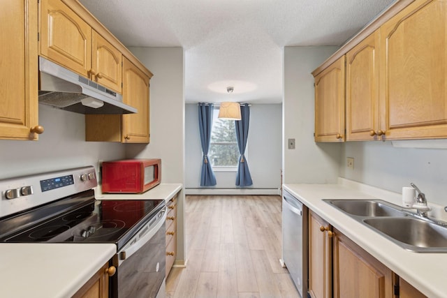 kitchen with sink, baseboard heating, stainless steel appliances, light wood-type flooring, and light brown cabinets