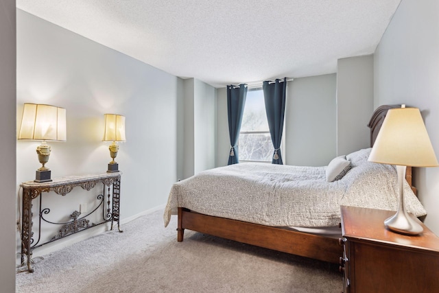 carpeted bedroom featuring a textured ceiling