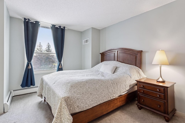 carpeted bedroom featuring a textured ceiling