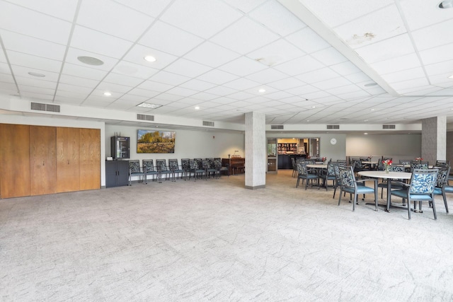 interior space featuring carpet floors and a paneled ceiling