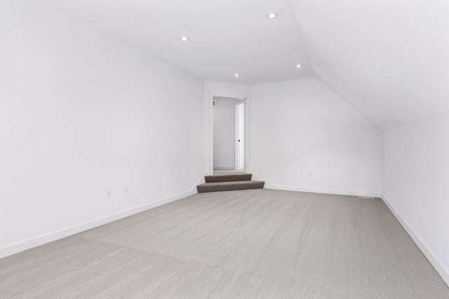 bonus room featuring lofted ceiling, recessed lighting, light colored carpet, and baseboards