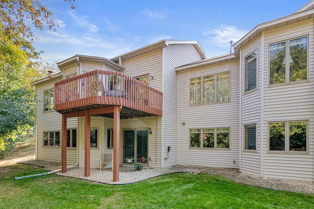 back of property with a deck and a lawn