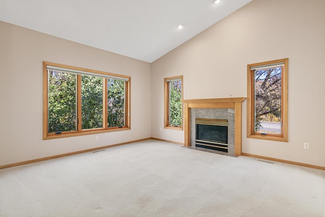 unfurnished living room featuring visible vents, carpet floors, and a healthy amount of sunlight