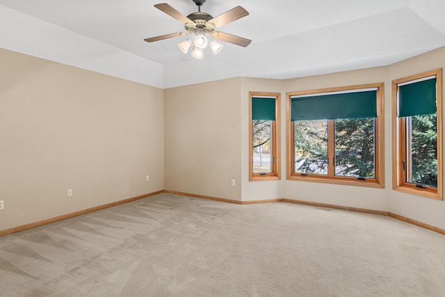 unfurnished room featuring carpet flooring, visible vents, baseboards, and ceiling fan