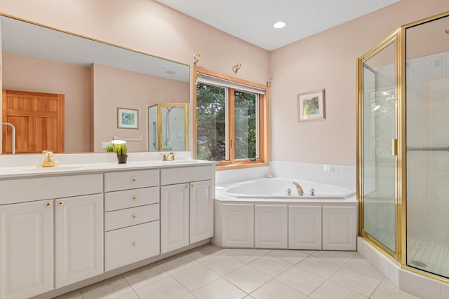 full bathroom featuring double vanity, a stall shower, a sink, tile patterned flooring, and a garden tub