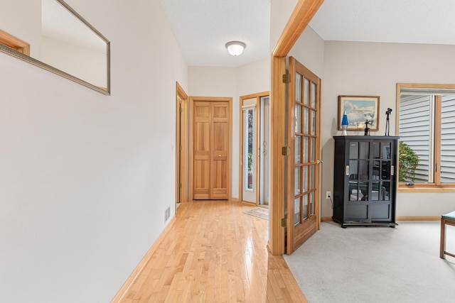 hallway featuring baseboards and wood-type flooring