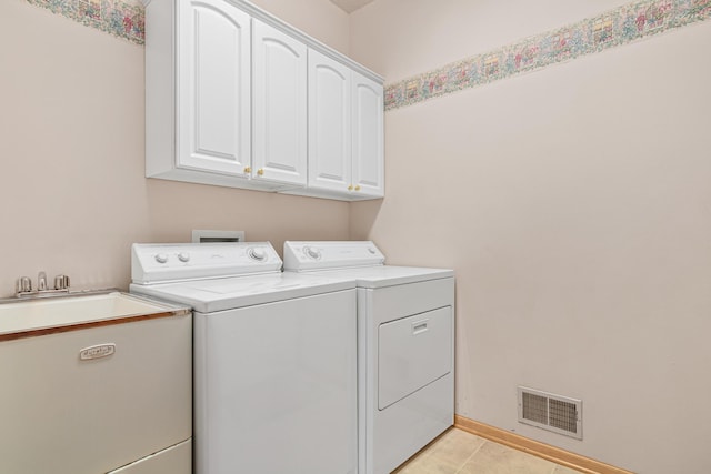 laundry room featuring light tile patterned floors, visible vents, cabinet space, a sink, and independent washer and dryer