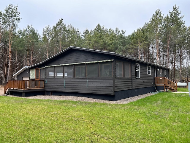 exterior space with a wooden deck and a lawn