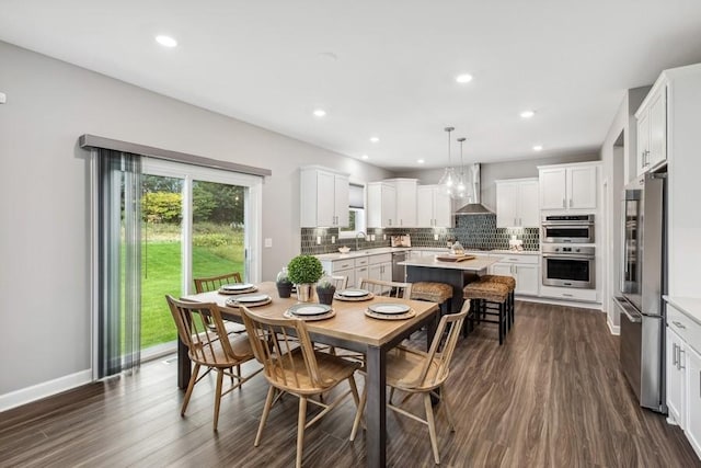 dining space with sink and dark wood-type flooring