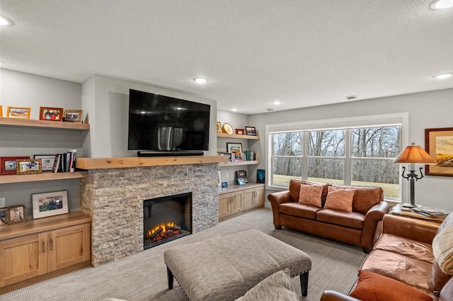 living room with a fireplace, light colored carpet, and a textured ceiling