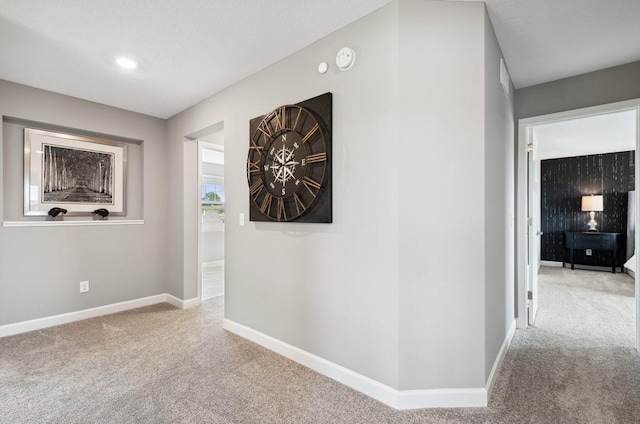 hallway with light colored carpet