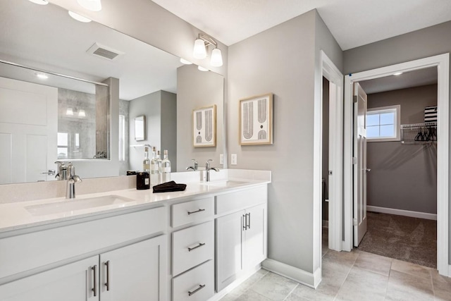 bathroom with tile patterned floors and vanity