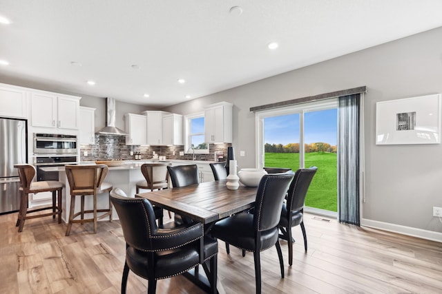 dining area featuring sink and light hardwood / wood-style floors