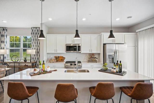 kitchen featuring a large island, stainless steel appliances, and decorative light fixtures